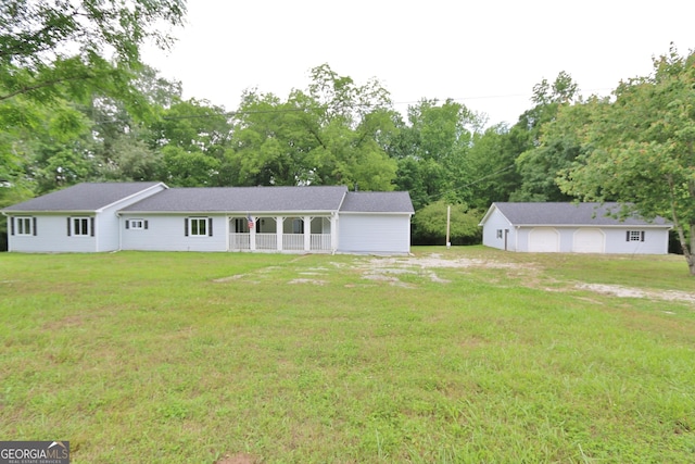 3434 Union Point Rd, Union Point, GA 30669 - view of front of house with a front lawn, view of scattered trees, covered porch, and an outdoor structure