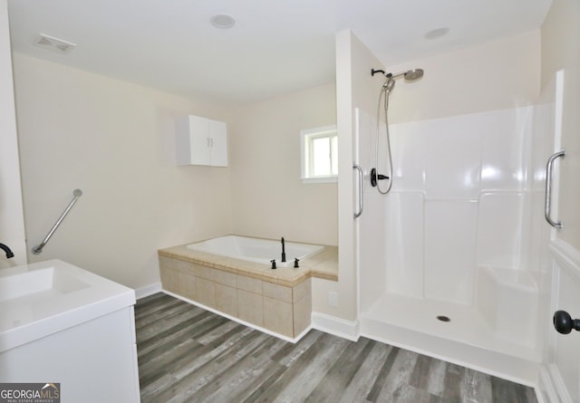 3434 Union Point Rd, Union Point, GA 30669 - bathroom featuring wood finished floors, a garden tub, a shower, and vanity