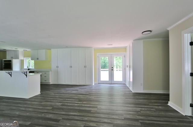 3434 Union Point Rd, Union Point, GA 30669 - unfurnished living room featuring french doors, ornamental molding, dark wood-type flooring, and plenty of natural light