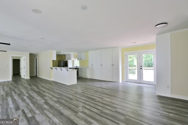 3434 Union Point Rd, Union Point, GA 30669 - unfurnished living room with dark wood-style floors, french doors, and baseboards
