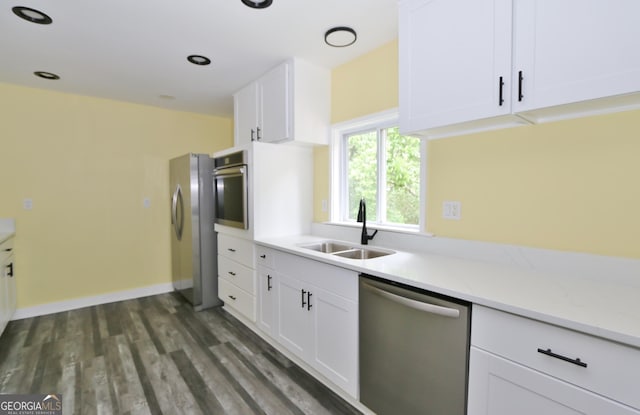3434 Union Point Rd, Union Point, GA 30669 - kitchen with appliances with stainless steel finishes, a sink, white cabinetry, dark wood finished floors, and baseboards