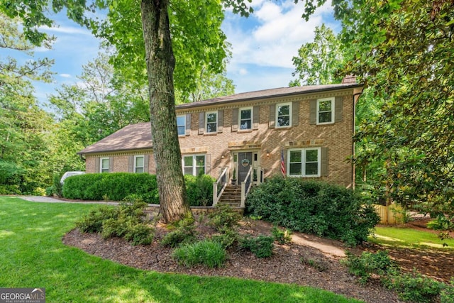 5676 Mount Berry Ln, Peachtree Corners, GA 30092 - colonial inspired home with a chimney and brick siding