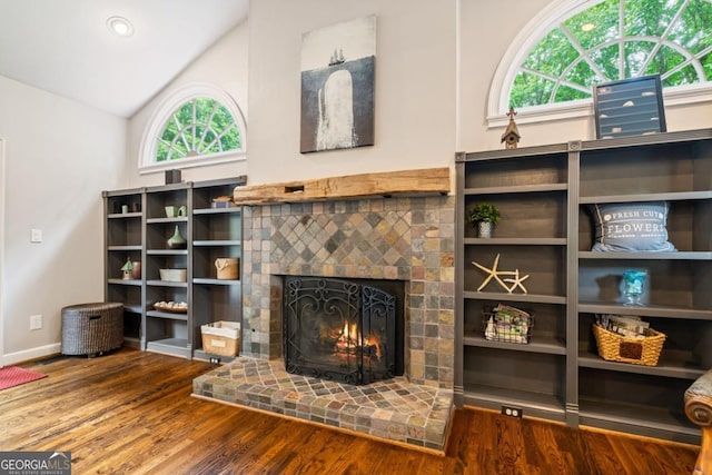 5676 Mount Berry Ln, Peachtree Corners, GA 30092 - unfurnished living room featuring plenty of natural light, a fireplace, wood finished floors, and lofted ceiling