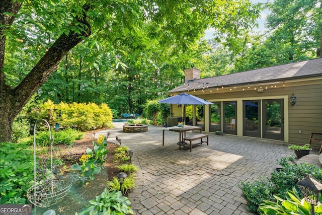 5676 Mount Berry Ln, Peachtree Corners, GA 30092 - view of patio / terrace with an outdoor fire pit