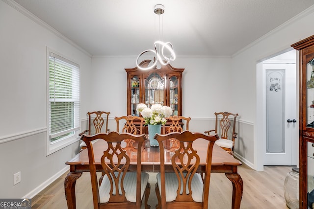 212 Teepee Trl, Whitesburg, GA 30185 - dining room featuring light wood-style flooring, crown molding, and healthy amount of natural light