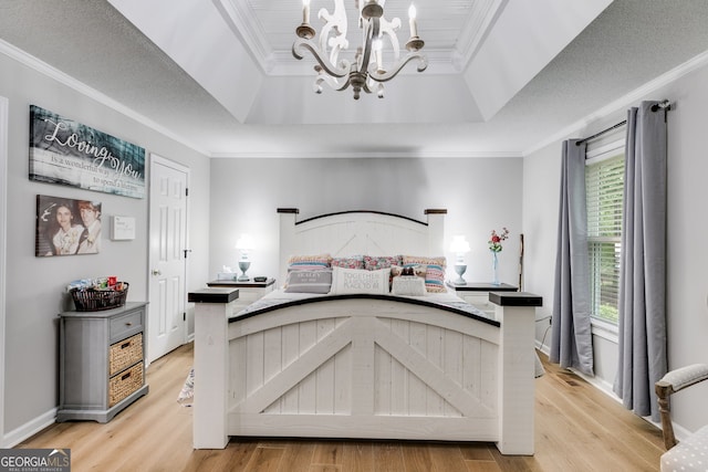212 Teepee Trl, Whitesburg, GA 30185 - bedroom with ornamental molding, a chandelier, light wood-style flooring, and a tray ceiling