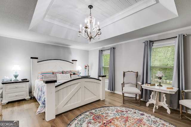 212 Teepee Trl, Whitesburg, GA 30185 - bedroom with a raised ceiling, a chandelier, ornamental molding, and wood finished floors
