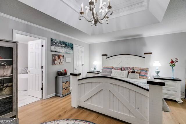 212 Teepee Trl, Whitesburg, GA 30185 - bedroom with a chandelier, ornamental molding, a raised ceiling, light wood finished floors, and ensuite bathroom