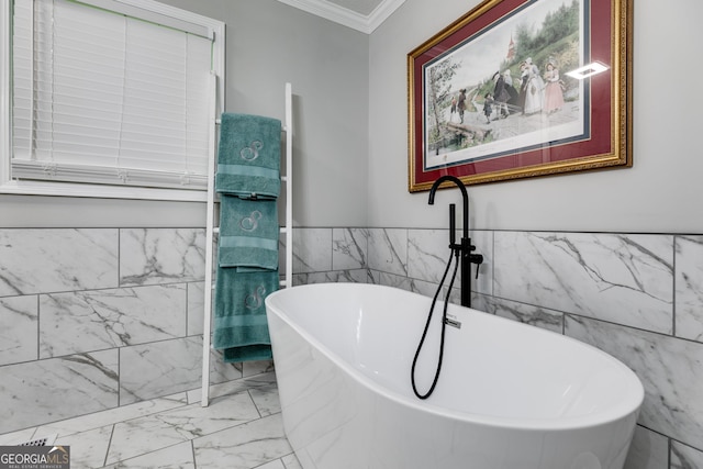 212 Teepee Trl, Whitesburg, GA 30185 - bathroom with marble finish floors, tile walls, a freestanding bath, crown molding, and wainscoting