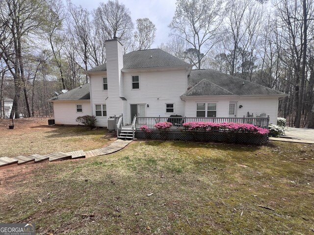 212 Teepee Trl, Whitesburg, GA 30185 - rear view of house with a deck, a yard, a chimney, and a shingled roof