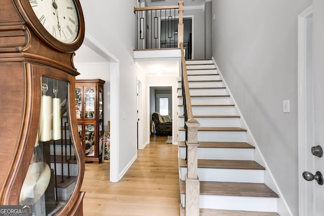 212 Teepee Trl, Whitesburg, GA 30185 - staircase featuring wood finished floors, ornamental molding, and a high ceiling