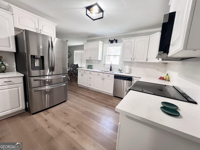 212 Teepee Trl, Whitesburg, GA 30185 - kitchen featuring appliances with stainless steel finishes, white cabinetry, light wood-style flooring, light countertops, and crown molding