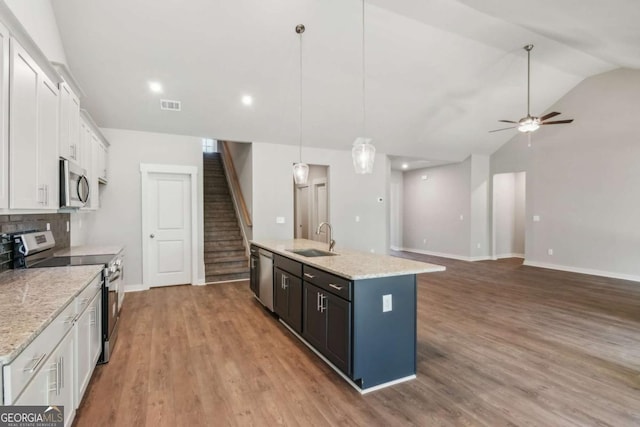 4300 Links Blvd, Jefferson, GA 30549 - kitchen featuring appliances with stainless steel finishes, a sink, white cabinets, a center island with sink, and a ceiling fan