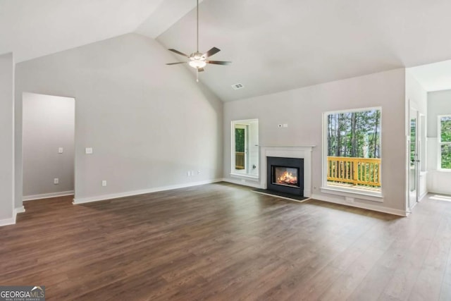 4300 Links Blvd, Jefferson, GA 30549 - unfurnished living room with high vaulted ceiling, a ceiling fan, a glass covered fireplace, dark wood finished floors, and baseboards