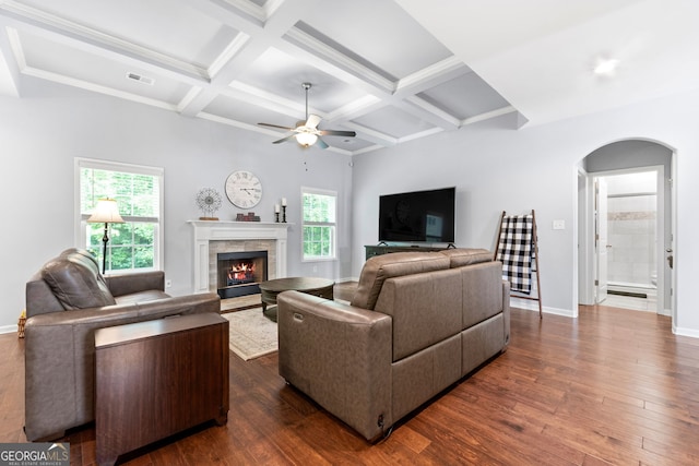 8 Saint Charles Ave, Sharpsburg, GA 30277 - living room featuring arched walkways, coffered ceiling, a lit fireplace, dark wood-style floors, and a ceiling fan