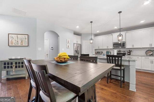 8 Saint Charles Ave, Sharpsburg, GA 30277 - dining area featuring arched walkways, dark wood-style flooring, and recessed lighting