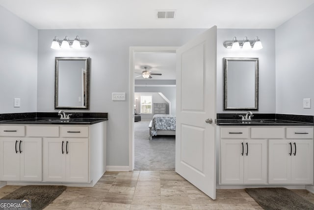 8 Saint Charles Ave, Sharpsburg, GA 30277 - ensuite bathroom with ceiling fan, two vanities, and baseboards
