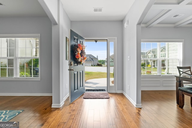 8 Saint Charles Ave, Sharpsburg, GA 30277 - foyer with light wood-style floors, plenty of natural light, arched walkways, and beam ceiling