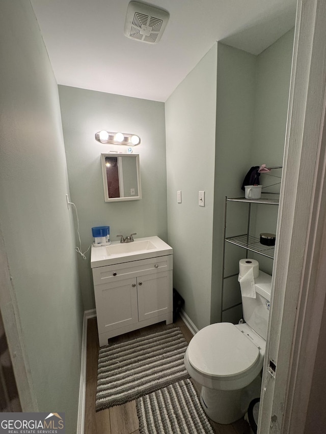 2935 Southshore Dr, Macon, GA 31204 - bathroom featuring baseboards, vanity, toilet, and wood finished floors
