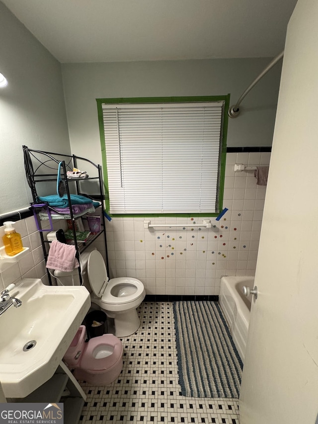 2935 Southshore Dr, Macon, GA 31204 - full bath featuring tile walls, toilet, a sink, and wainscoting