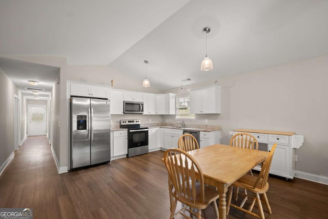 1672 Meadow Lark Ln, Gainesville, GA 30501 - dining space featuring lofted ceiling and dark wood-type flooring