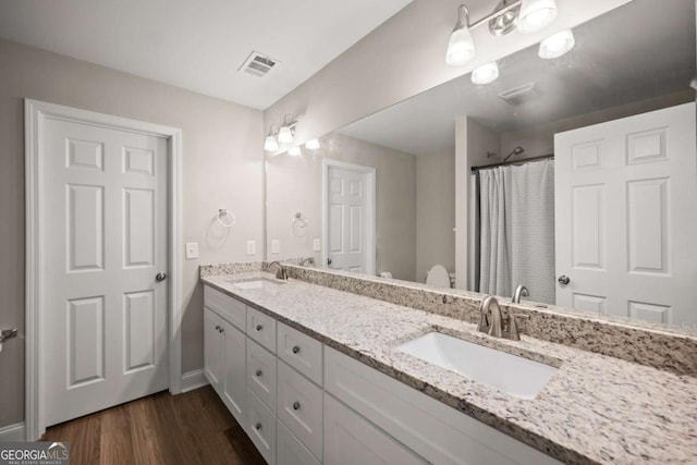 1672 Meadow Lark Ln, Gainesville, GA 30501 - full bath featuring double vanity, wood finished floors, and a shower with curtain