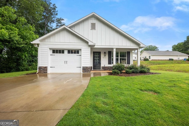 1672 Meadow Lark Ln, Gainesville, GA 30501 - view of front of home featuring board and batten siding, concrete driveway, a garage, covered porch, and a front lawn