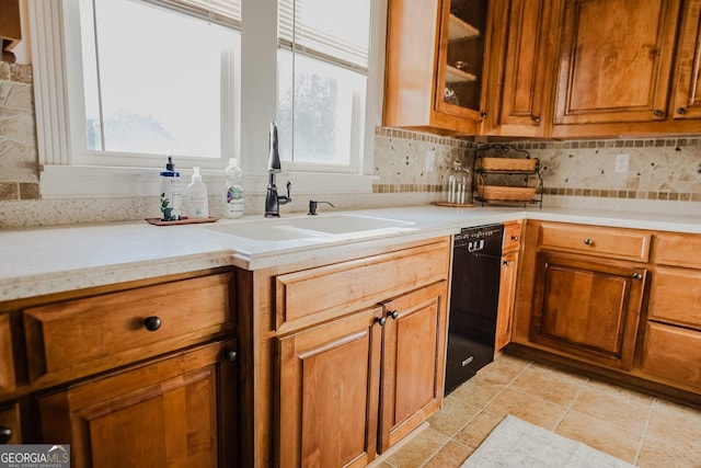 428 Elm St, Barnesville, GA 30204 - kitchen featuring dishwasher, a sink, light countertops, brown cabinets, and tasteful backsplash