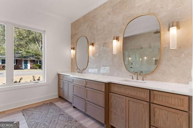 616 Neptune Way, Saint Simons, GA 31522 - bathroom featuring double vanity, tiled shower, and wood finished floors