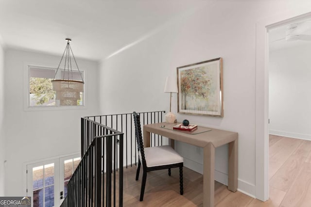616 Neptune Way, Saint Simons, GA 31522 - hall featuring an upstairs landing, healthy amount of natural light, wood finished floors, and a chandelier