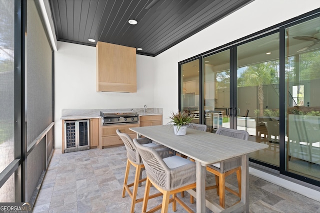 616 Neptune Way, Saint Simons, GA 31522 - sunroom / solarium featuring beverage cooler, area for grilling, and outdoor dining area
