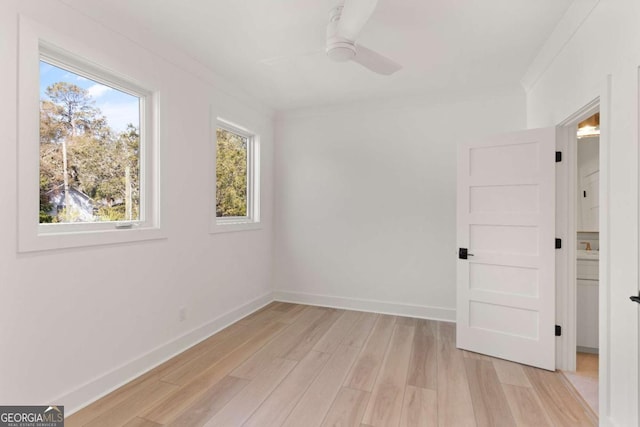 616 Neptune Way, Saint Simons, GA 31522 - empty room featuring ceiling fan, light wood-type flooring, and ornamental molding