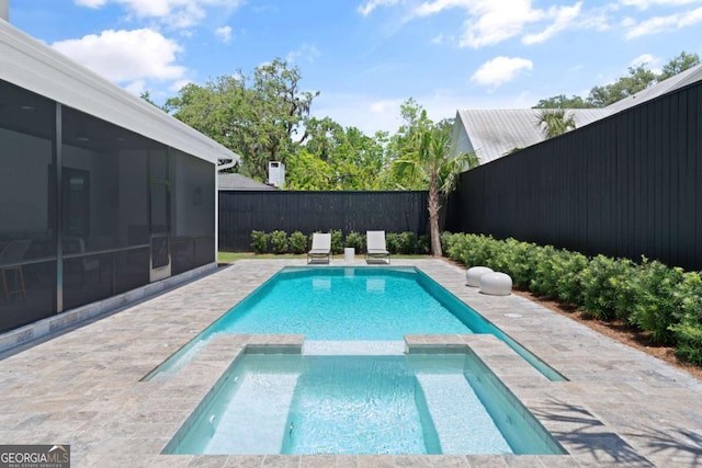 616 Neptune Way, Saint Simons, GA 31522 - view of swimming pool featuring a sunroom, a fenced backyard, a pool with connected hot tub, and a patio area