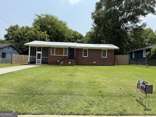 2642 Reynolds Dr, Macon, GA 31206 - ranch-style house featuring a sunroom, brick siding, metal roof, and driveway