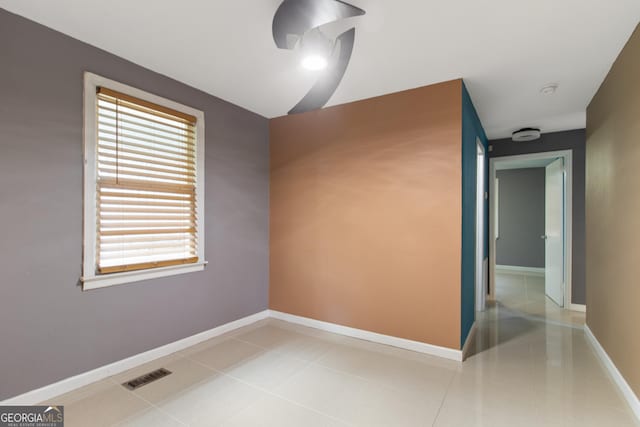 2642 Reynolds Dr, Macon, GA 31206 - empty room with baseboards, tile patterned flooring, and a smoke detector