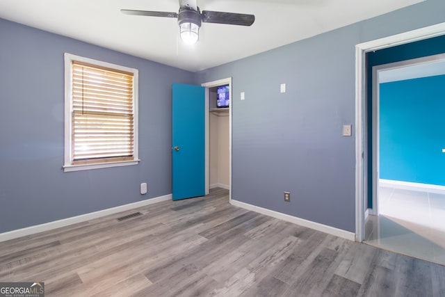 2642 Reynolds Dr, Macon, GA 31206 - unfurnished bedroom with wood finished floors, baseboards, a closet, and a ceiling fan