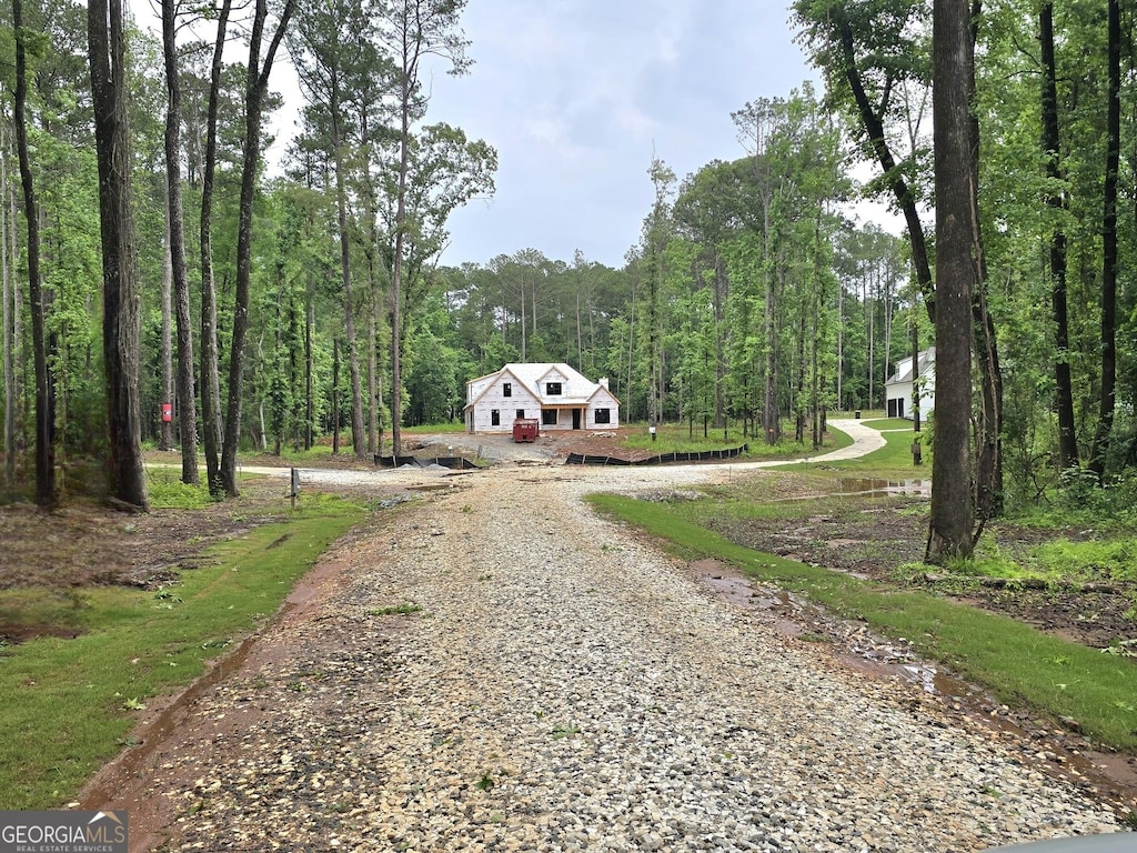 2039 Fischer Rd, Sharpsburg, GA 30277 - view of dirt / gravel driveway featuring a forest view