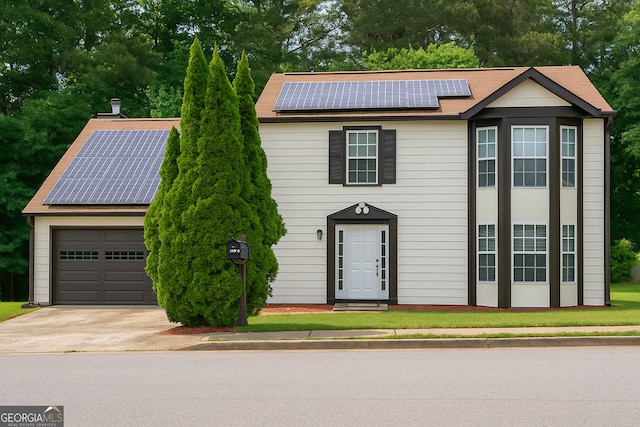 3255 Hunters Crossing Pt, Lithonia, GA 30038 - view of front of house featuring solar panels, a garage, and driveway