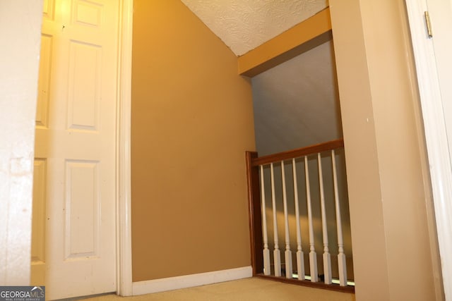 3255 Hunters Crossing Pt, Lithonia, GA 30038 - stairway featuring lofted ceiling and a textured ceiling