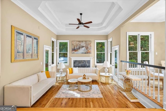 4670 Hamden Forest Dr SW, Atlanta, GA 30331 - living room with ornamental molding, a ceiling fan, plenty of natural light, wood finished floors, and a tray ceiling