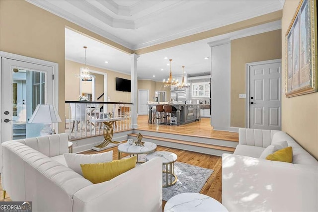 4670 Hamden Forest Dr SW, Atlanta, GA 30331 - living room featuring a chandelier, light wood-type flooring, crown molding, ornate columns, and recessed lighting