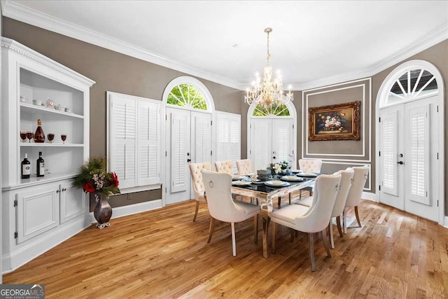 4670 Hamden Forest Dr SW, Atlanta, GA 30331 - dining area with a chandelier, crown molding, and light wood-type flooring