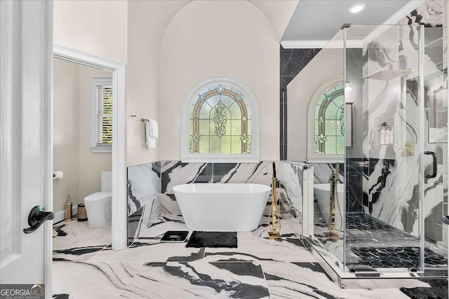 4670 Hamden Forest Dr SW, Atlanta, GA 30331 - bathroom featuring a freestanding tub, marble tiled floors, a marble finish shower, tile walls, and crown molding