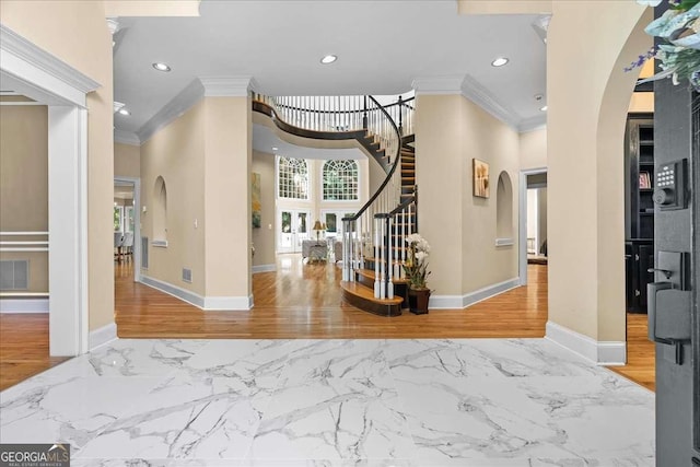 4670 Hamden Forest Dr SW, Atlanta, GA 30331 - foyer entrance with arched walkways, crown molding, marble finish flooring, recessed lighting, and stairway