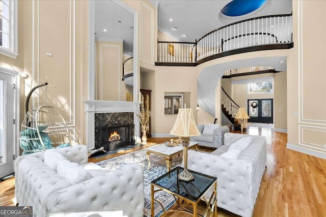 4670 Hamden Forest Dr SW, Atlanta, GA 30331 - living room with stairs, wood finished floors, a high ceiling, a premium fireplace, and healthy amount of natural light