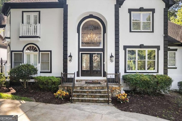 4670 Hamden Forest Dr SW, Atlanta, GA 30331 - view of front facade with french doors, stucco siding, and roof with shingles