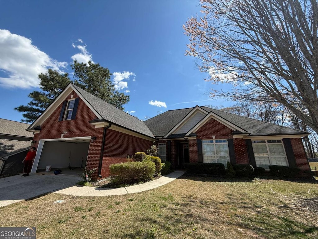 2728 Limestone, Gainesville, GA 30501 - view of front of home with brick siding, driveway, a front yard, and an attached garage