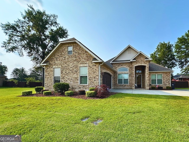 307 Legacy Park Dr, Perry, GA 31069 - view of front facade featuring driveway, a front yard, an attached garage, and brick siding