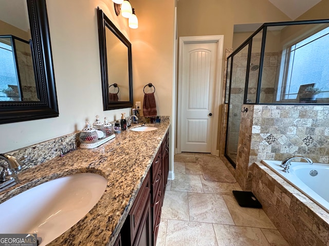 307 Legacy Park Dr, Perry, GA 31069 - bathroom featuring a garden tub, a shower stall, double vanity, stone tile flooring, and healthy amount of natural light