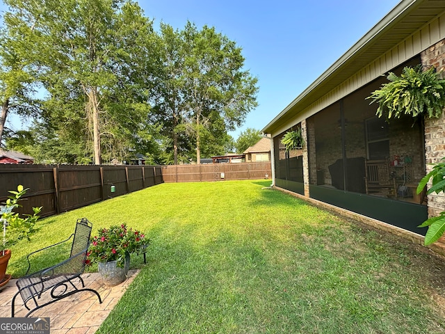307 Legacy Park Dr, Perry, GA 31069 - fenced backyard with a sunroom